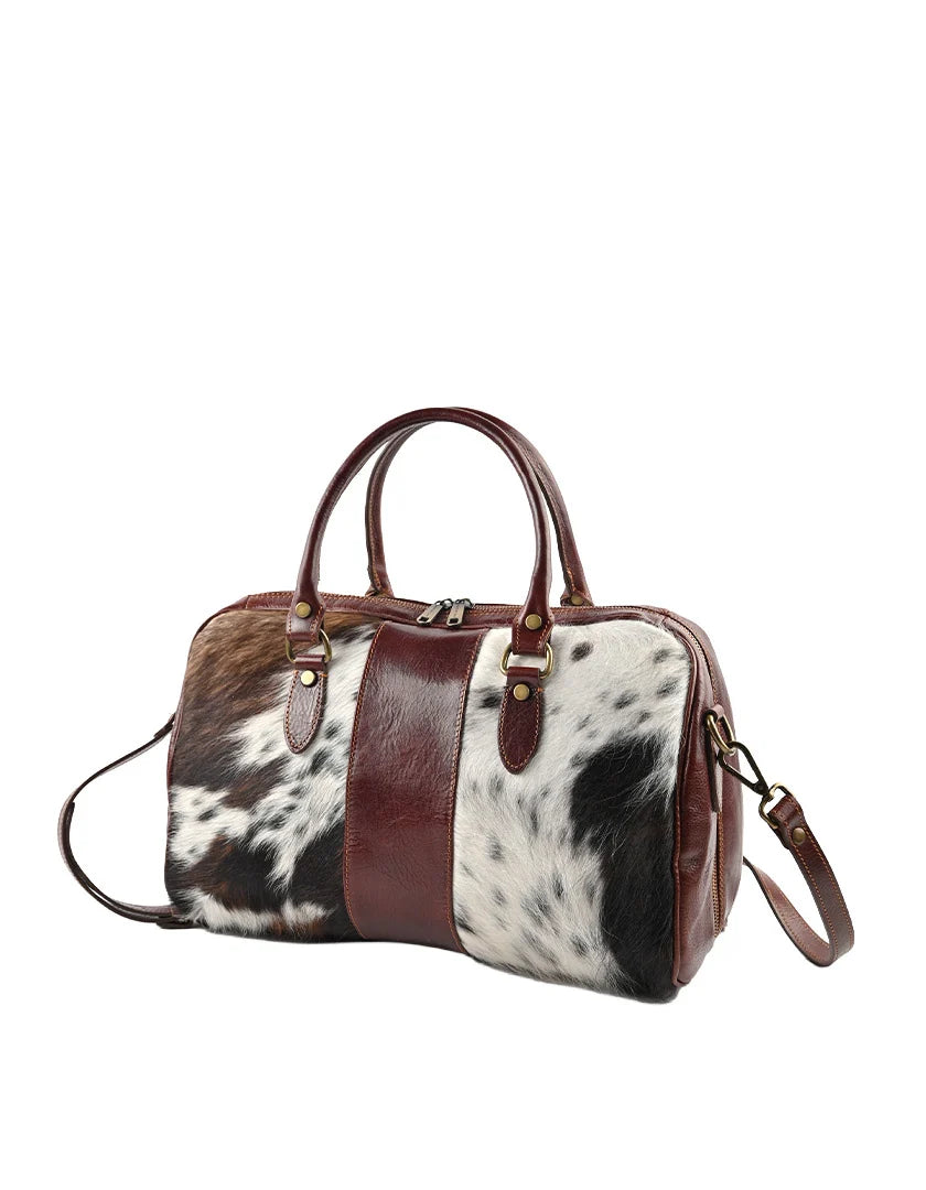 Lederen bowlingtas met een trendy koeprint.